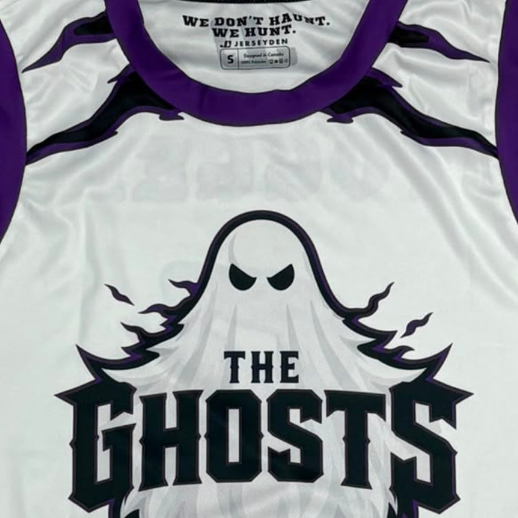A white sleeveless athletic jersey with purple trim, featuring a ghost graphic and the text 'THE GHOSTS' on the front, laid flat on a gray surface.
