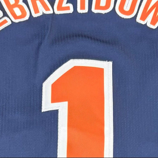 A navy blue basketball jersey with orange trim.