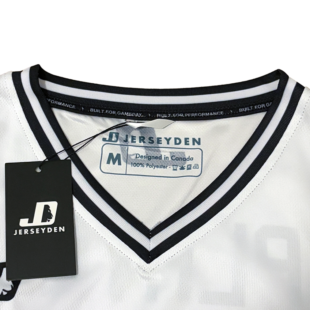 White V-neck athletic jersey with black trim, featuring a black hangtag and interior neck label with JERSEYDEN branding.