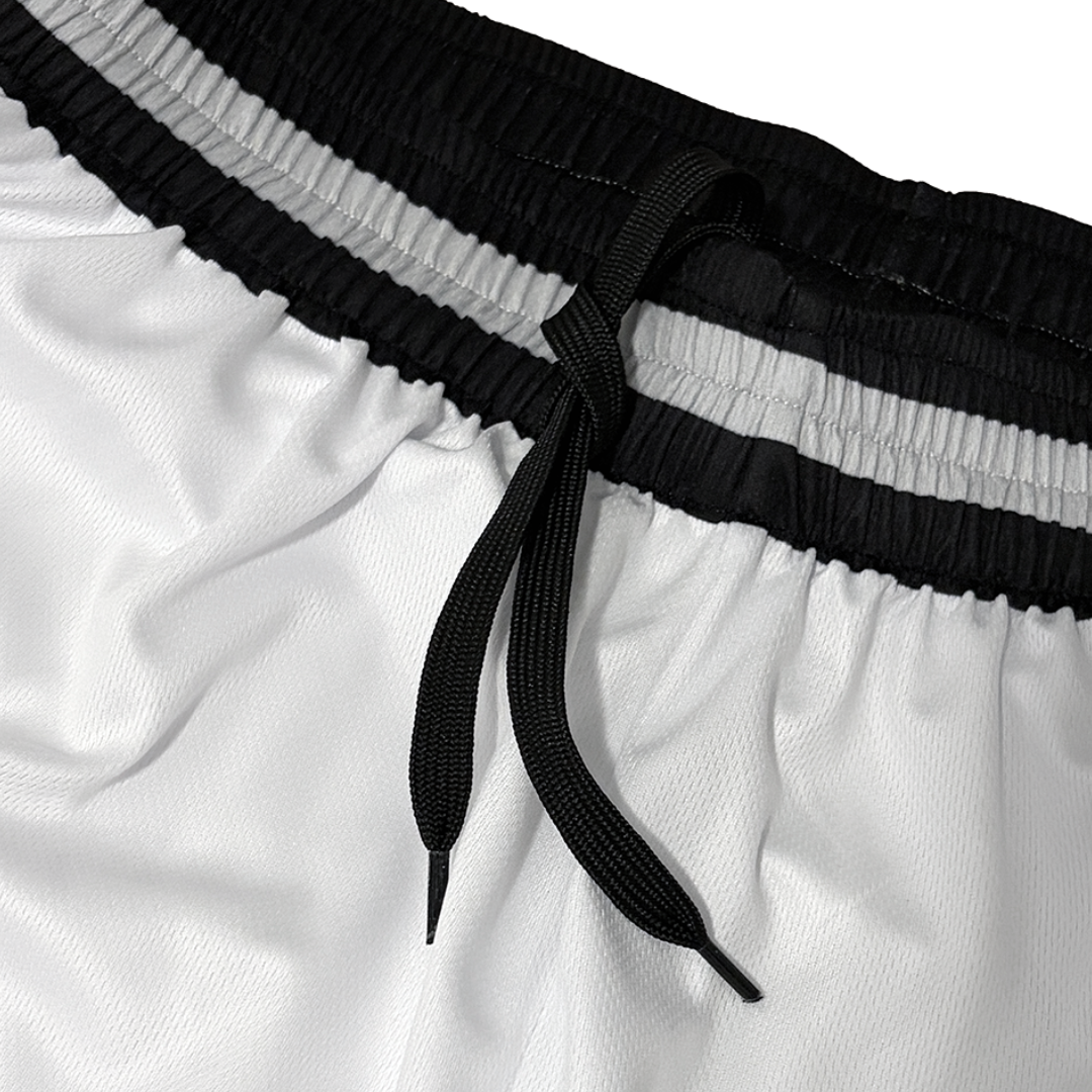 Close-up of white athletic shorts with a black elastic waistband and black drawstring, photographed against a white background.