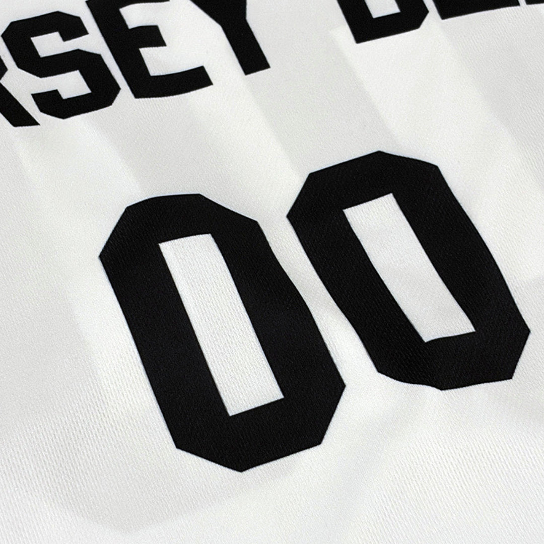 Close-up of a white sports jersey showing black lettering that reads 'JERSEY DEN' and large black numbers '00' on the back.
